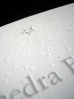 Silver ink and a blind impression for the second color